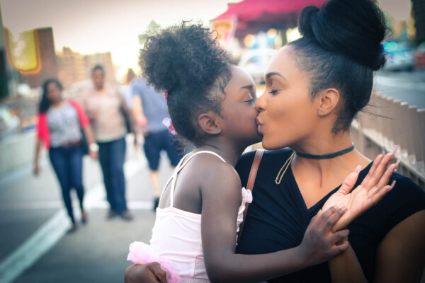 Woman kissed by daughter