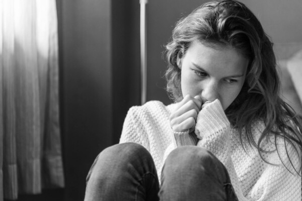Sad girl sitting alone