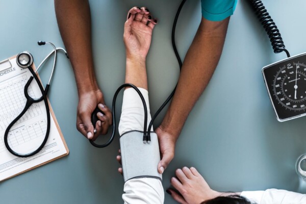 Doctor taking patient's blood pressure