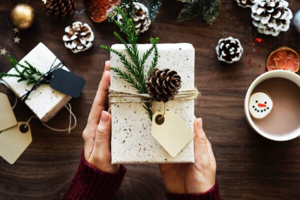 Person giving a Christmas gift