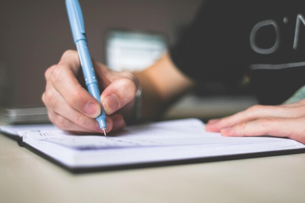 Person writing in notebook