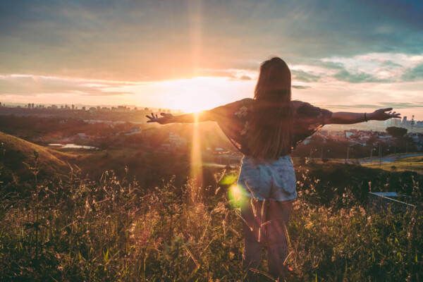 Woman enjoying sunset over city