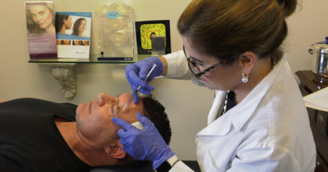 Doctor giving man a Botox injection