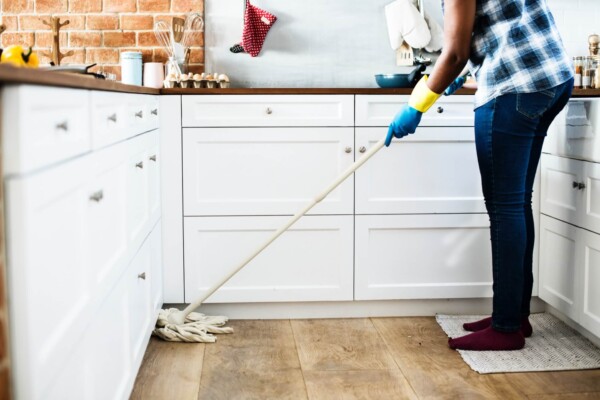 Person mopping a kitchen