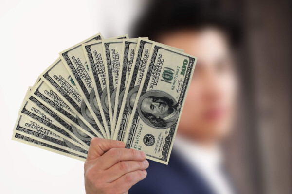 Man holding $100 bills