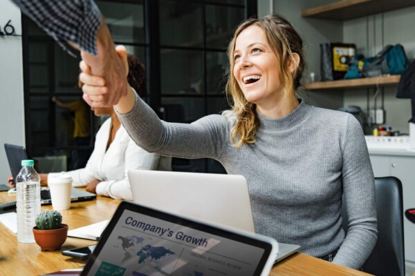 Woman shaking hands with colleague iin office