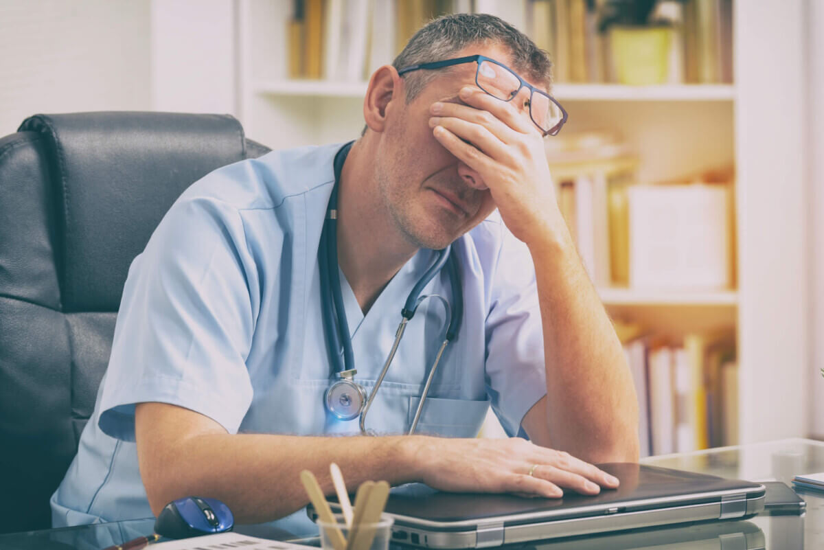 Overworked doctor in his office