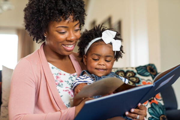Mother reading a book to her daughter