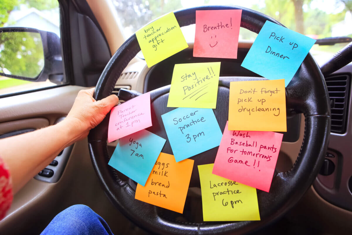 Steering wheel covered in notes as a reminder of errands to do
