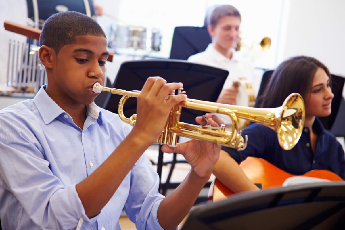 Teen Playing Trumpet In High School Band