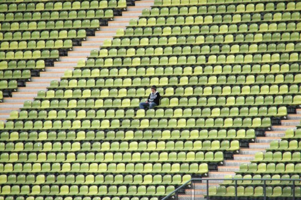 Person sitting alone in college football stadium