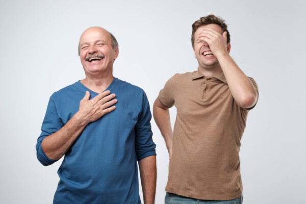 Dad jokes: Father, son laughing after telling a jokeDad jokes: Father, son laughing after telling a joke