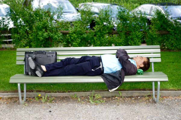 Man sleeping or taking a nap on a bench