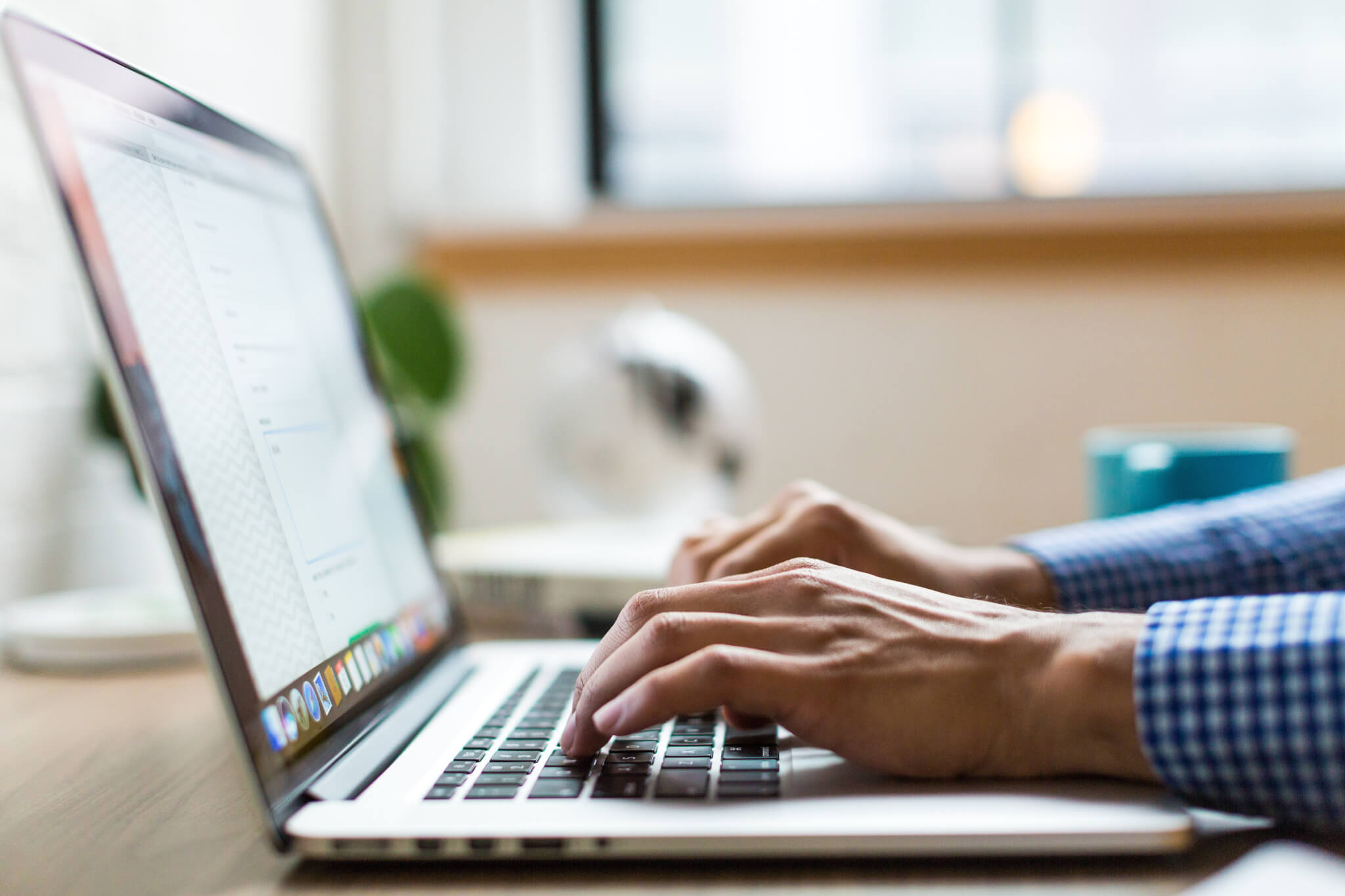 Person typing on laptop computer keyboard