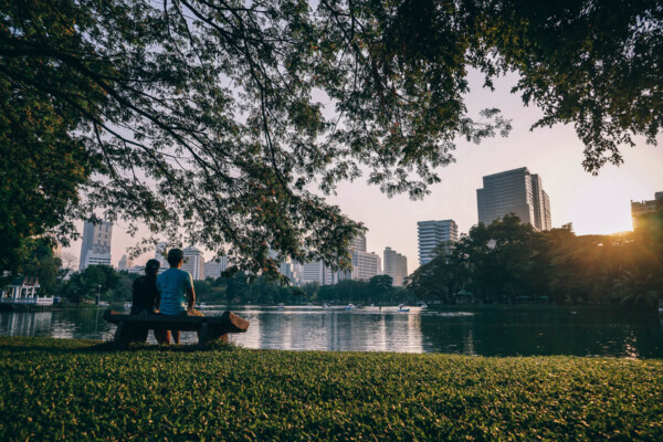 People sitting on a bench at a city park