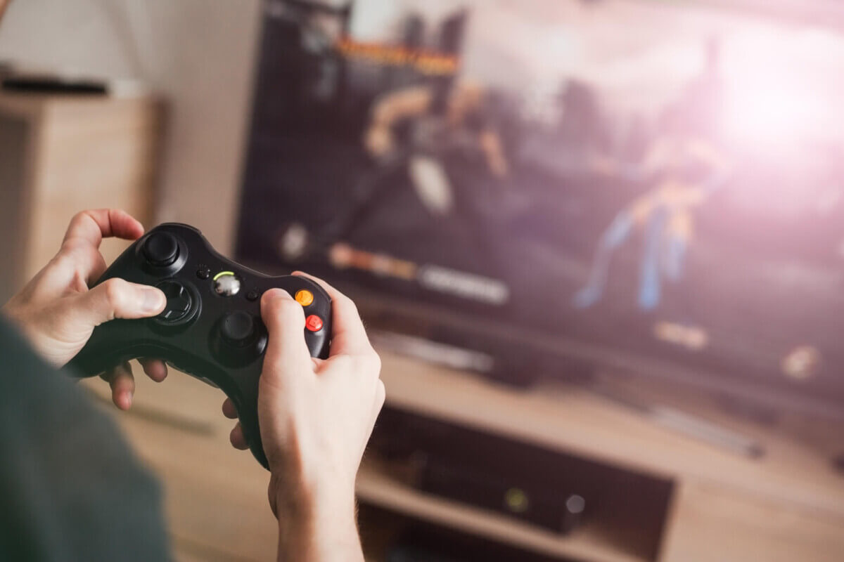 The guy plays the console on video games