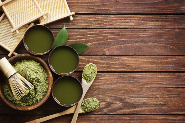 Green tea in bowls, spoons
