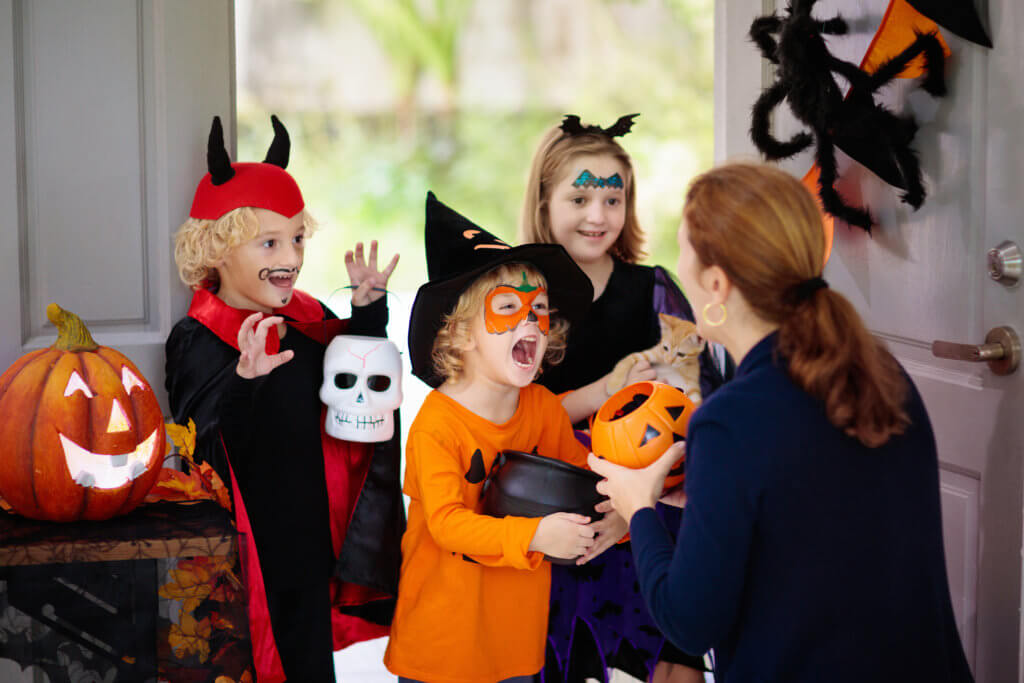 Trick or treaters getting Halloween candy