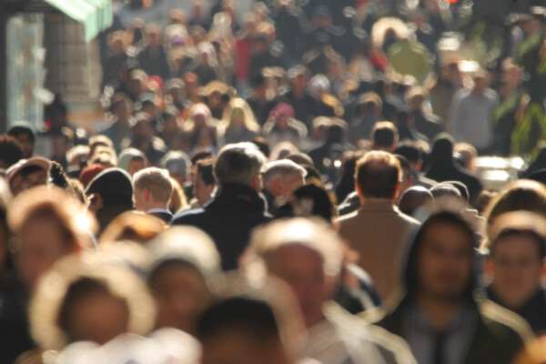 Crowd of people walking on street