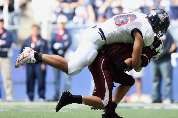 College football quarterback being tackled