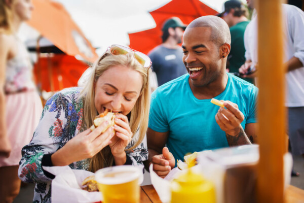Happy couple eating at restaurant on a date