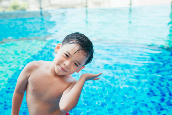Young swimmer with water in his ear
