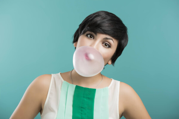 Woman blowing bubble with gum