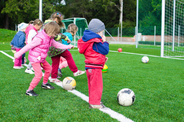 Young children playing soccer