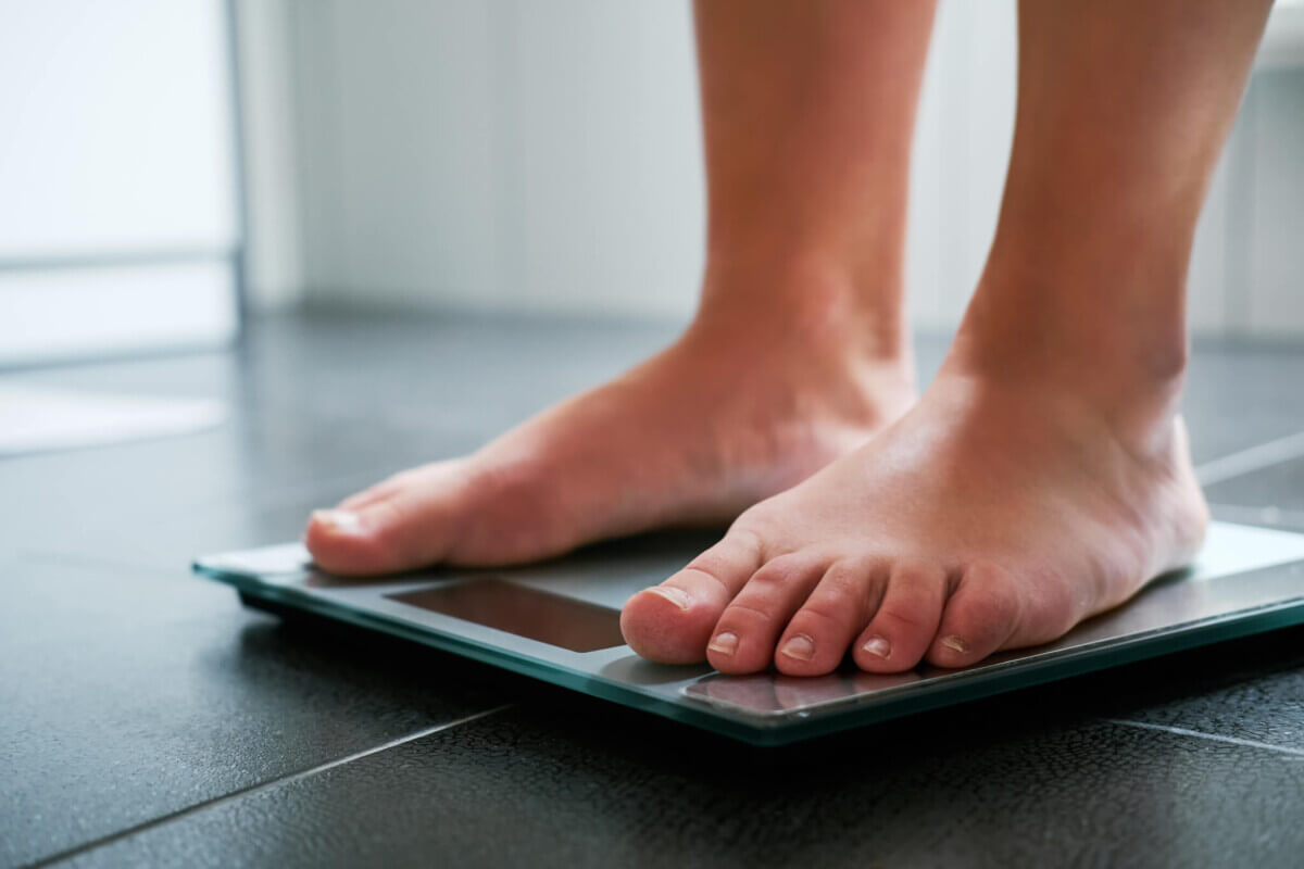 Female bare feet on the digital scale in the bathroom