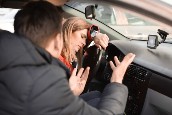 Tired couple having argument in car