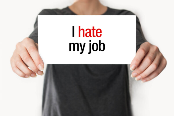 Woman holding "I Hate My Job" sign
