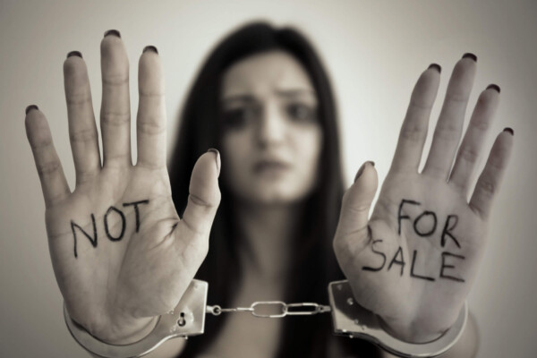 Sex trafficking: Woman in handcuffs with hands showing, "Not For Sale"