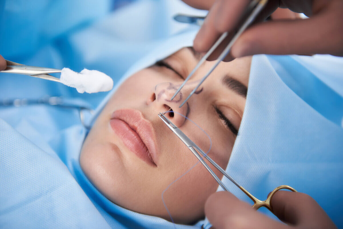 Doctor making operation for young beautiful woman