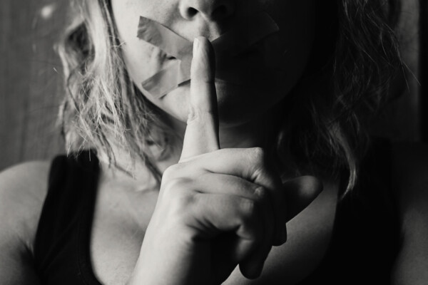 Sad, scared woman self-silencing