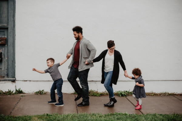 Family of four walking on the sidewalk