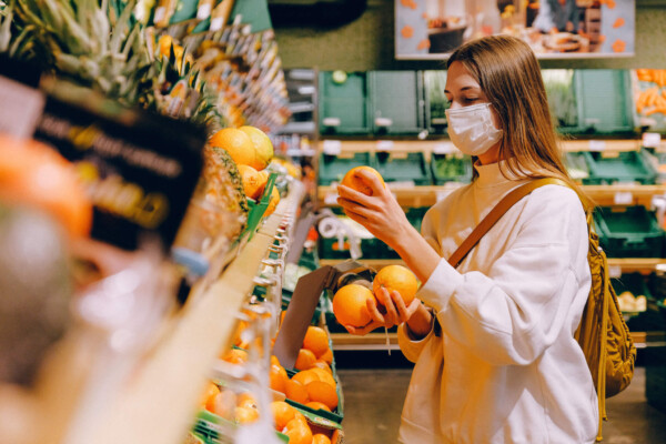 Woman wearing mask while shopping at grocery store during coronavirus outbreak