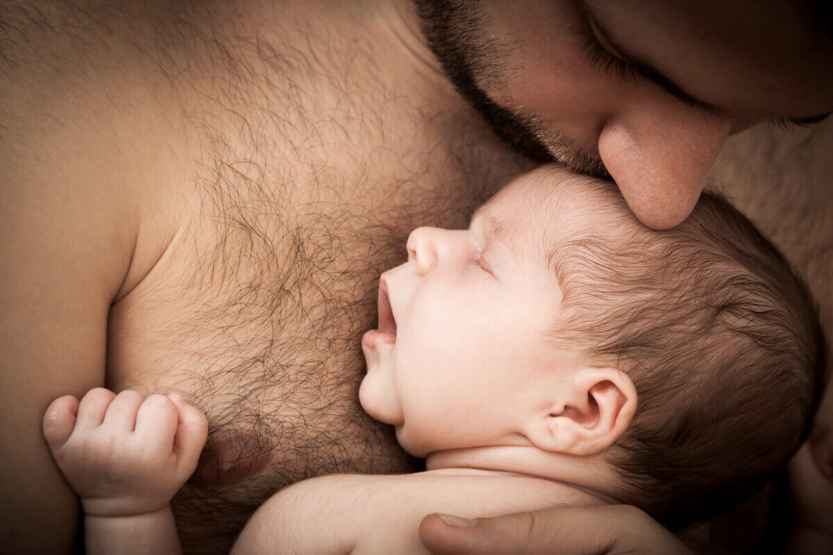 newborn child and father
