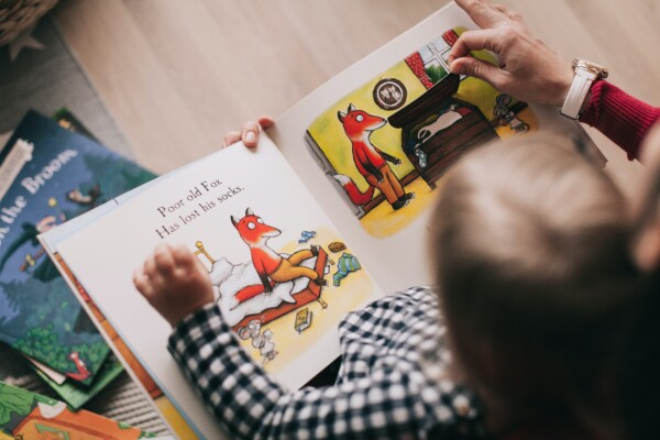 Parent reading book to child