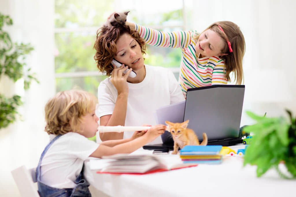 Mother doing work, stressed with children