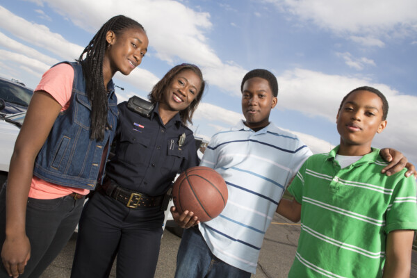 Police officer talking with kids on the street