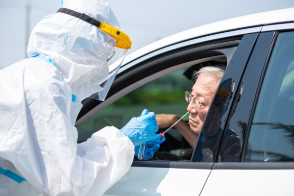 Man getting coronavirus / covid-19 test in his car