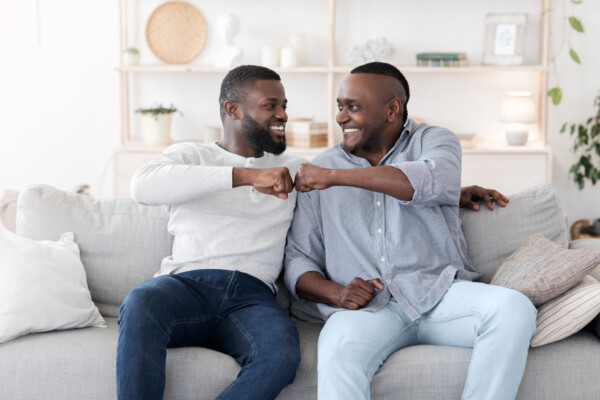 Father son having fist bump together