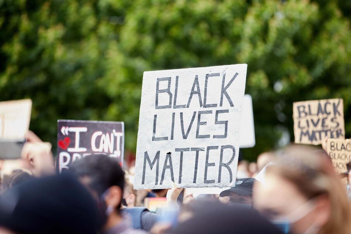Sign “BLACK LIVES MATTER” amongst others at the Police Violence march for George Floyd