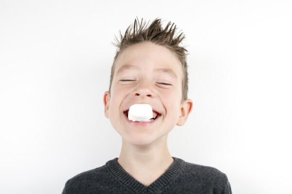 Boy eating a marshmallow
