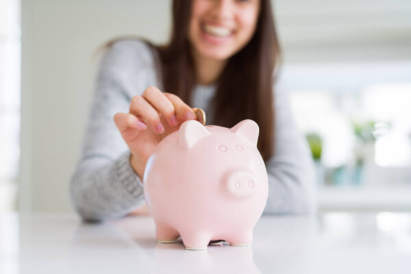 Woman saving money in piggy bank