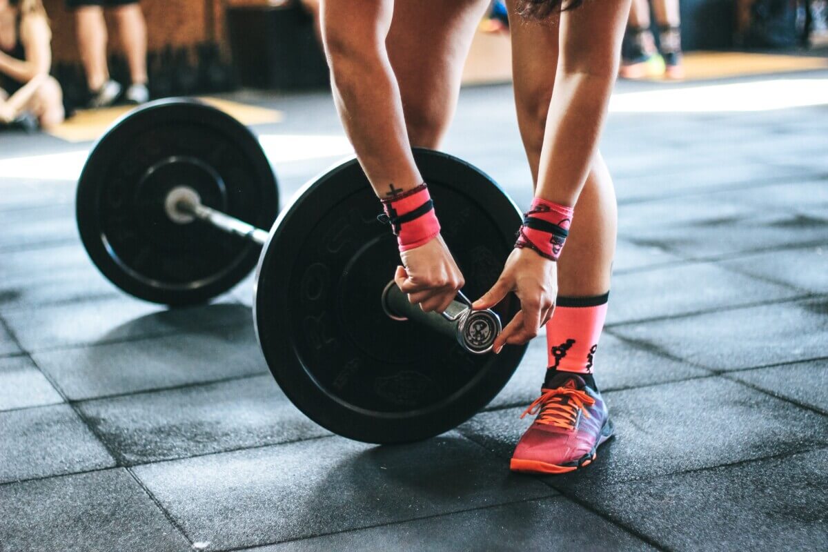 person-holding-black-barbell-703014