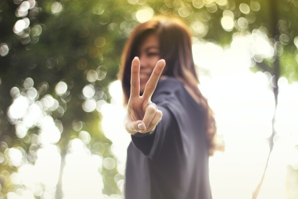 Woman showing 'peace' sign