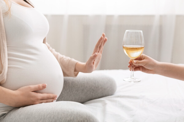Pregnant woman declines glass of wine, alcohol