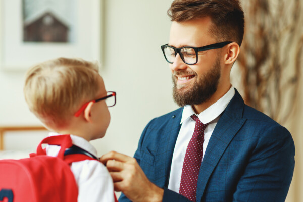 Father getting young son ready for school