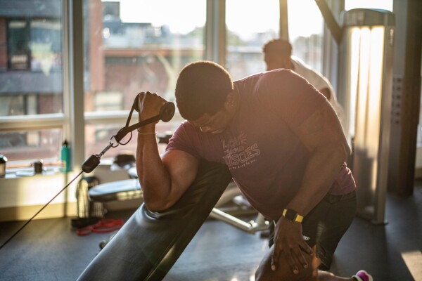 Man working out at gym, lifting weights
